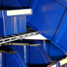 Blue plastic storage bins on metal shelves close up 24-bin rolling storage rack for garage organization