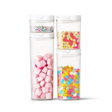 8-piece pantry storage container set with clear airtight containers holding colorful candies