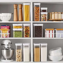 8-piece pantry storage container set from Brands For Less USA neatly organizing various dry foods on kitchen shelves