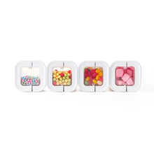 8-piece pantry storage container set with clear compartments holding colorful candies