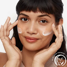 Woman applying Olay Total Effects face moisturizer SPF 15 cream to cheeks for skincare